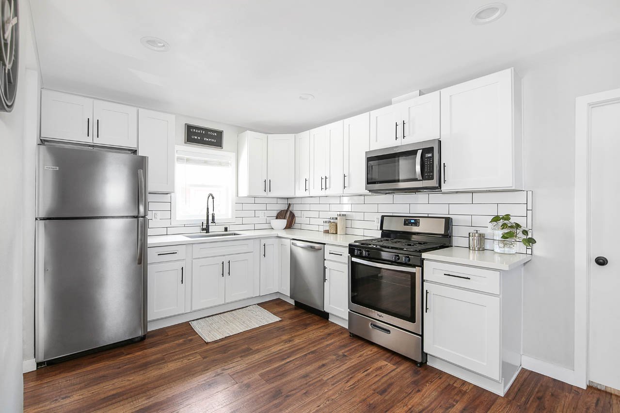 Whole-home remodel with a new white kitchen by T26 Design Build