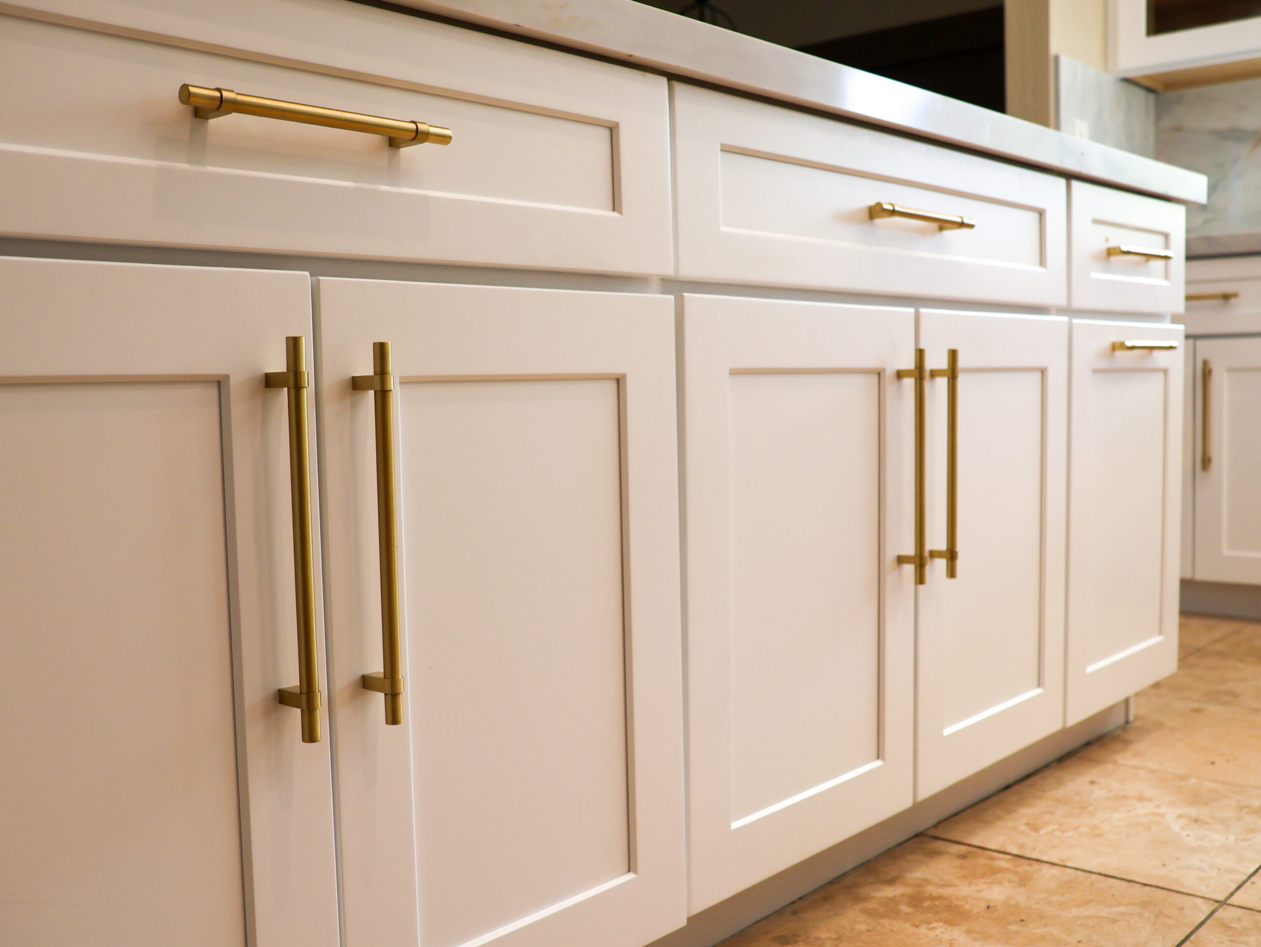 Custom cabinetry with gold hardware in a Scottsdale kitchen renovation